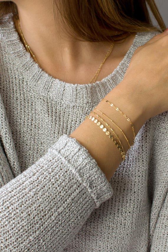 11) Layered ​Bracelets: Stack multiple bracelets together for a trendy, bohemian vibe that breathes life into your outfit